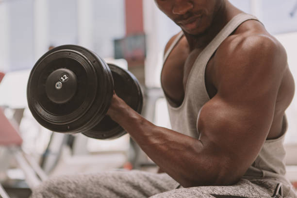 istock Handsome man working out at the gym 1205094456