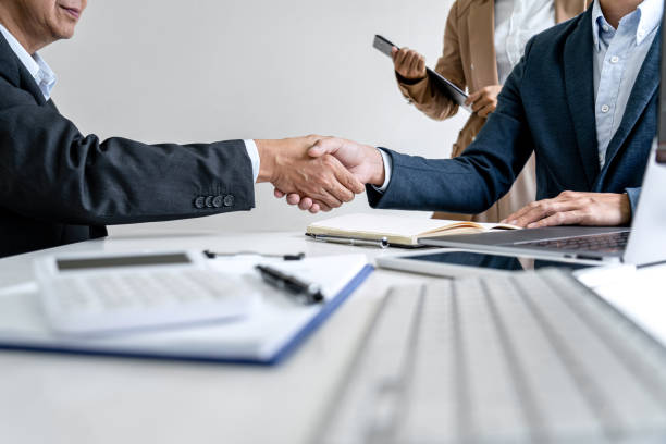 istock Teamwork partnership meeting concept, Two confident Business shaking hands after discussing good deal of trading contract and new projects for both companies 1205094730