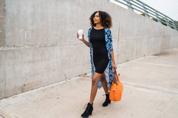 istock Afro american woman walking with coffee. 1205094842