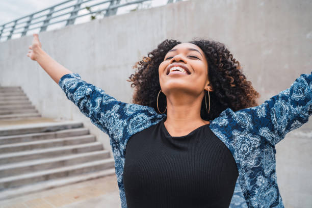 istock Afro american woman with arms raised. 1205094863