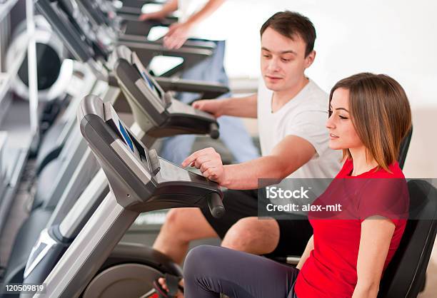 Personal Instructor Bike Trainer At Fitness Club Stock Photo - Download Image Now - 20-24 Years, Adult, Adults Only