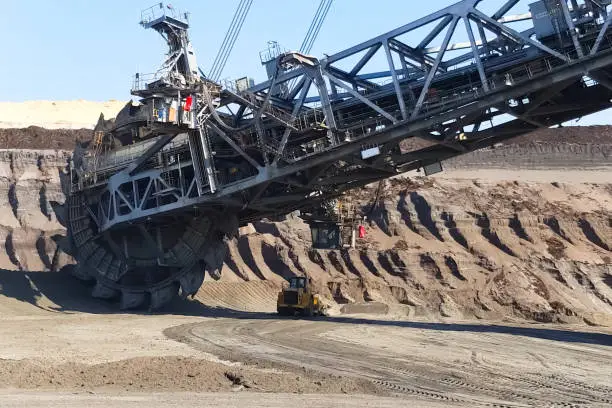 The work of a bucket wheel excavator in a quarry. Ore mining in a quarry.