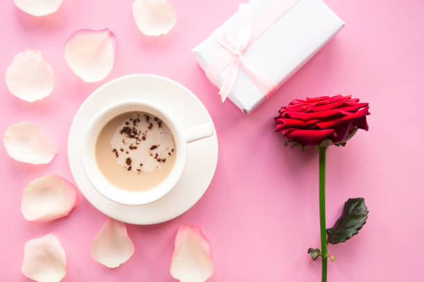 istock Love composition - coffee cup, gift box and red rose on pink background, top view. Valentines Day greeting card 1205099022