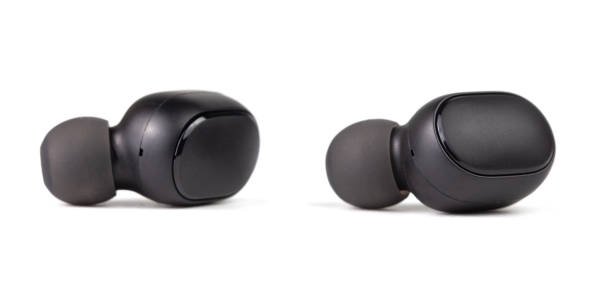 istock two black wireless earbuds isolated on white background - close-up with selective focus 1205099143