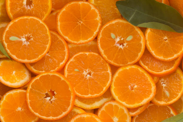 istock Round unpeeled orange slices background 1205099356