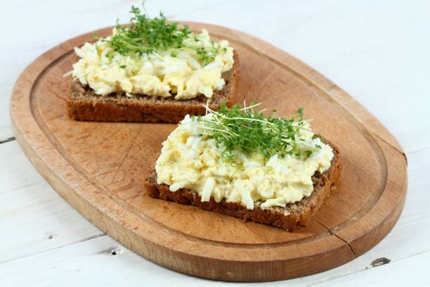 istock Egg salad over brown bread with garden cress 1205100593