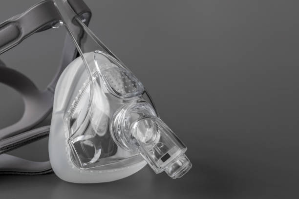 istock Sleep apnea CPAP mask on the grey background 1205104291
