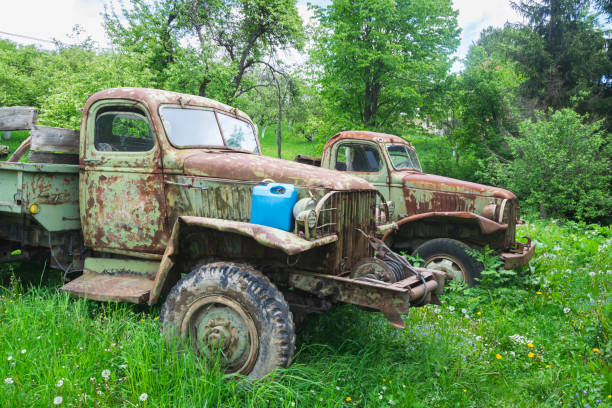 istock Old and rusty millitary trucks from worl war II which is now used by people for loading woods 1205104356