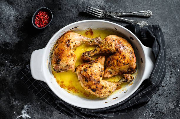 istock baked chicken drumsticks with thigh, spices. Black background. Top view 1205107208