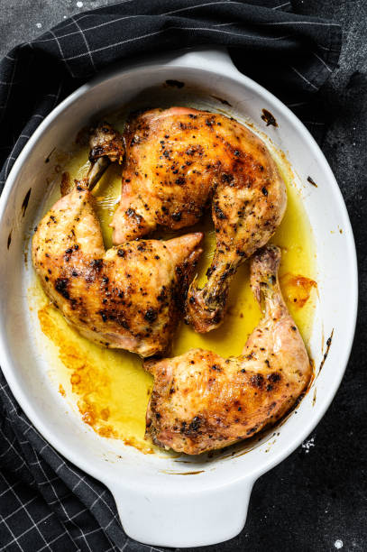 istock baked chicken drumsticks with thigh, spices. Black background. Top view 1205107237