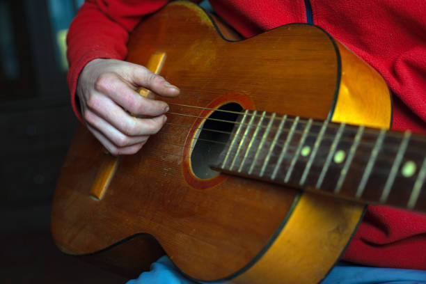 istock guy musician in red plays an acoustic guitar 1205108533