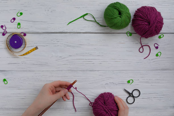 istock Background with knitting and crocheting tools and accessories, woman hands working cast on 1205112256