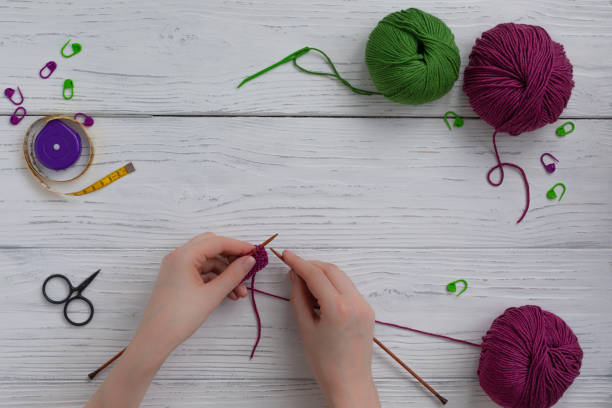 istock Background with knitting and crocheting tools and accessories, woman hands working 1205112258