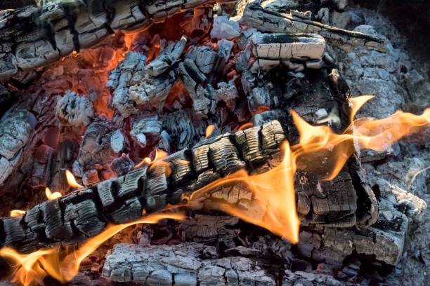 Close up of camp fire flames and fire in winter, switzerland. stock photo