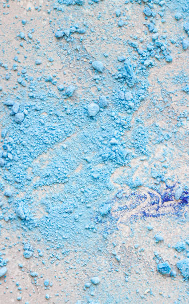 istock Close up of crumbled (crushed) small blue meringues, light grey stone background. 1205112479
