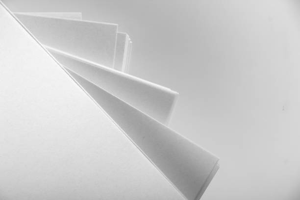 Several stacks of white paper on a white background
