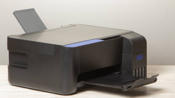 istock Black copier on white wooden table, closeup. 1205114976