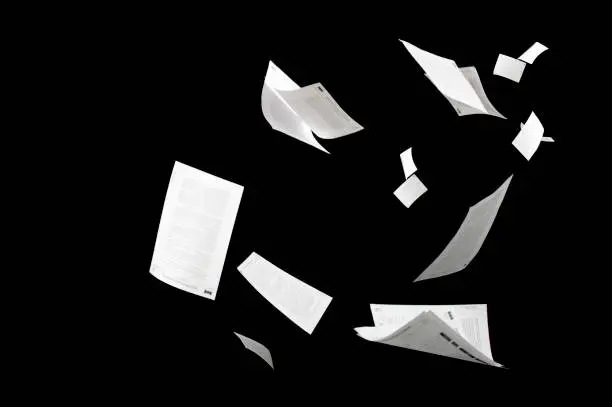 Photo of Many flying business documents isolated on black background Papers flying in air in business concept