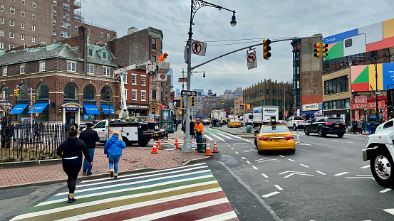 New York, NY, USA - February 10, 2020:  Rainbow colored crosswalk on Christopher Street in Greenwich Village near the Stonewall Inn.