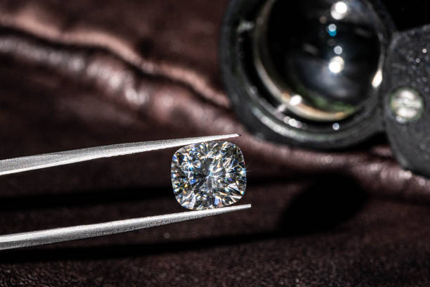 istock Diamond in Tweezers 1205118396