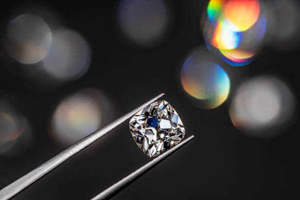istock Diamond in Tweezers 1205118581