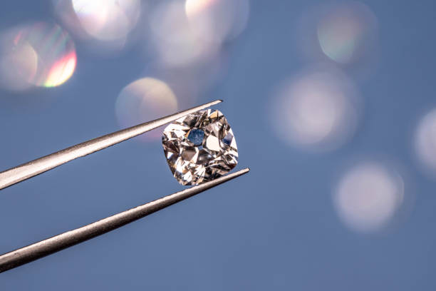 istock Diamond in Tweezers 1205118660