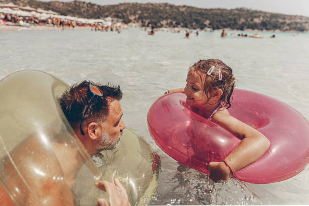 istock Young man spending time at the beach with his adorable daughter 1205119818