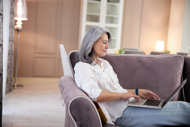 istock Confident computer user at home with gadget stock photo 1205122493