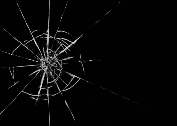 istock Round white cracks in glass on black background. 1205122901