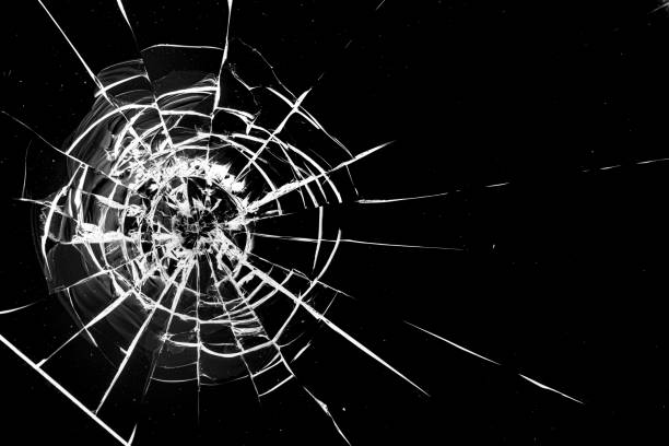 istock Round white cracks in glass on black background. 1205122910