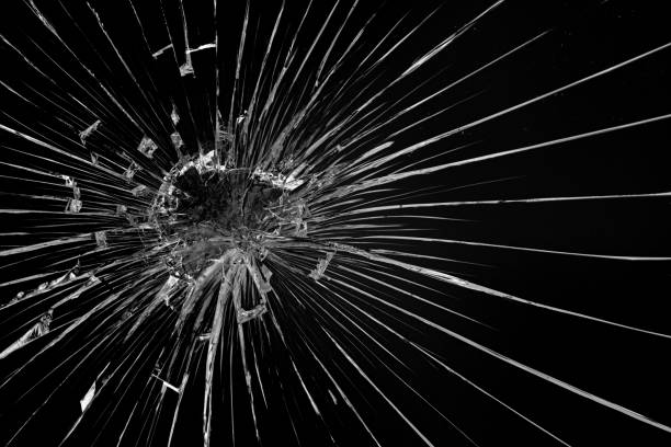 istock Round white cracks in glass on black background. 1205122911