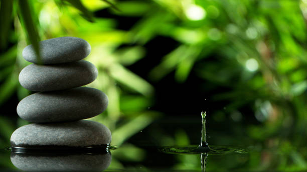 istock Dripping drops of water with black lava stones 1205125126