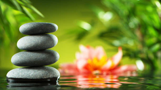 istock Tranquil water surface with black lava stones 1205125169