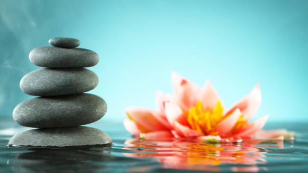 istock Tranquil water surface with black lava stones 1205125176