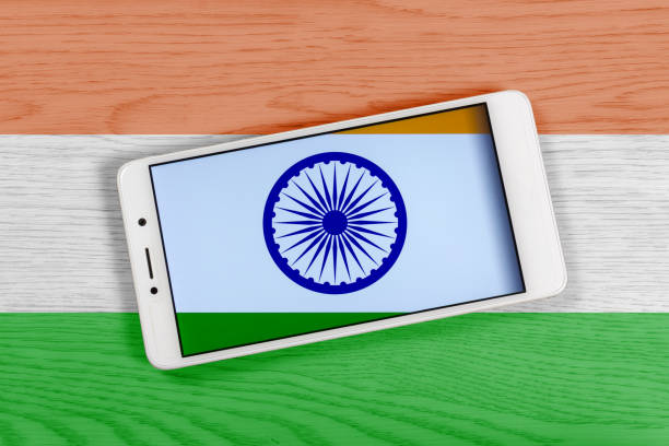 Creative Indian Flag Consisting of a Smartphone over a Wooden Background stock photo