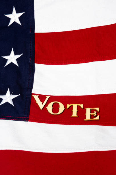 istock USA flag with the letters vote angled on a red stripe, vertical 1205127101