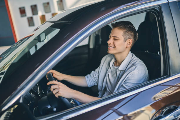 istock Caucasian man sitting in a new car. 1205128105