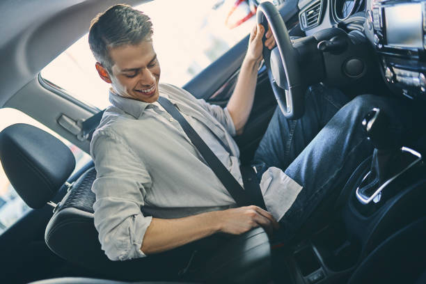 istock Stylish man sitting a new car and getting ready to drive. 1205128139