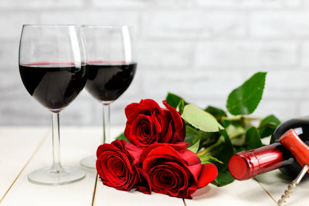 istock A glasses of wine, wine bottle and roses 1205128432