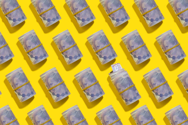 istock Argentine peso rolls flat lay on yellow background 1205129523