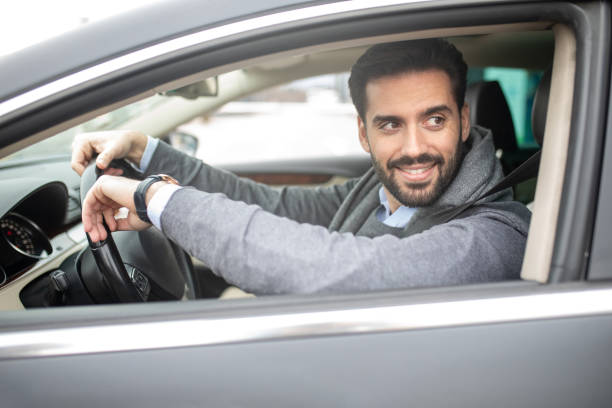 istock Handsome businessman driving car 1205130327