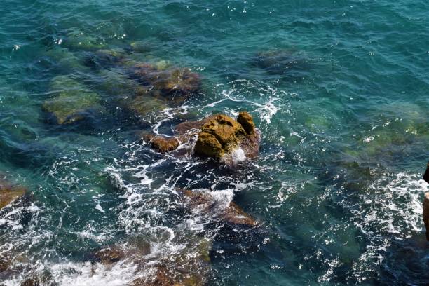 istock Rocks and blue sea aerial view 1205130611