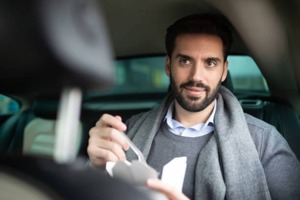 istock Businessma at the back sit of a car 1205130779