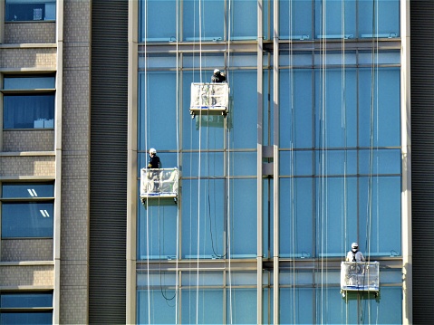 January. Japan. Cleaning of the  glass walls of skyscrapers.