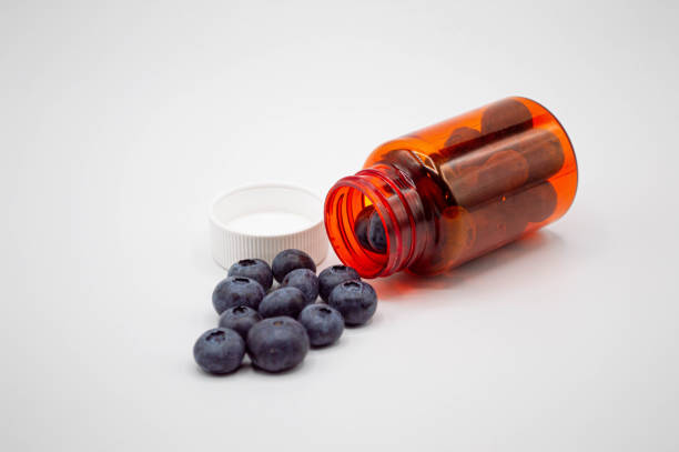 istock Prescription bottle with fresh blueberries pouring out 1205131572