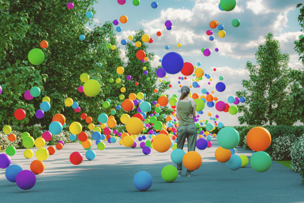 woman with bouncing spheres - color balls imagens e fotografias de stock