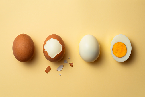 Phases of a boiled egg on yellow background.