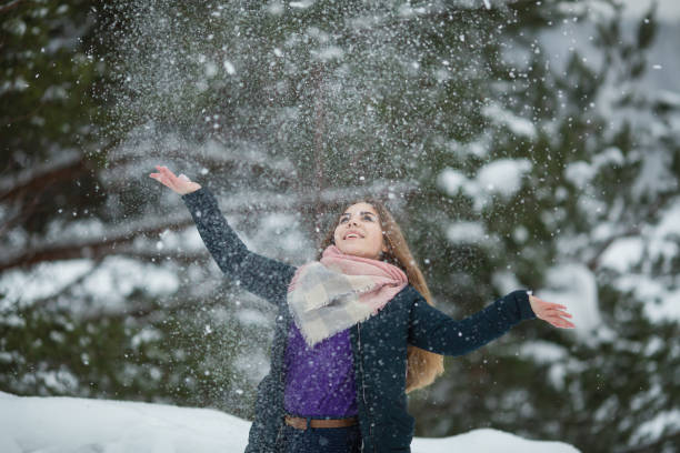 istock Fun teengirl playing with snow at winter. 1205136636