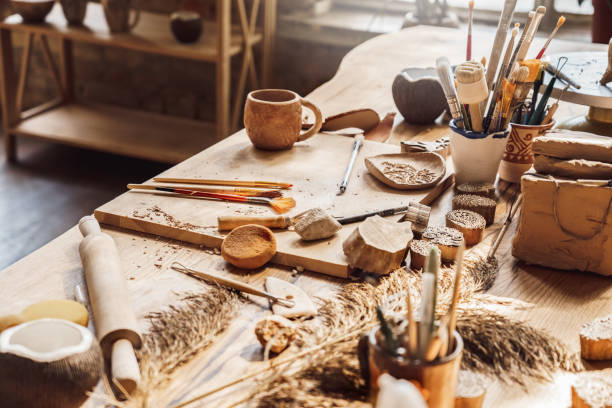 Craftsperson Workspace. Table with materials and tools for pottery isolated creative studio side view close-up Table with materials and tools for pottery making craftsperson workspace isolated no people creative studio side view close-up artist sculptor stock pictures, royalty-free photos & images