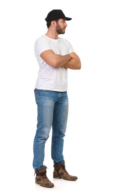 istock Serious Handsome Man Black Cap Is Standing With Arms Crossed And Looking Away 1205138032